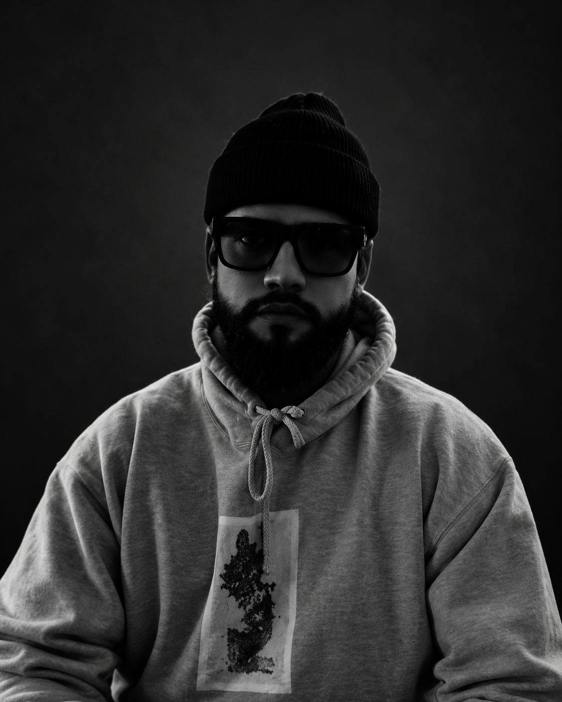 Oscar seated against an edited dark studio background.